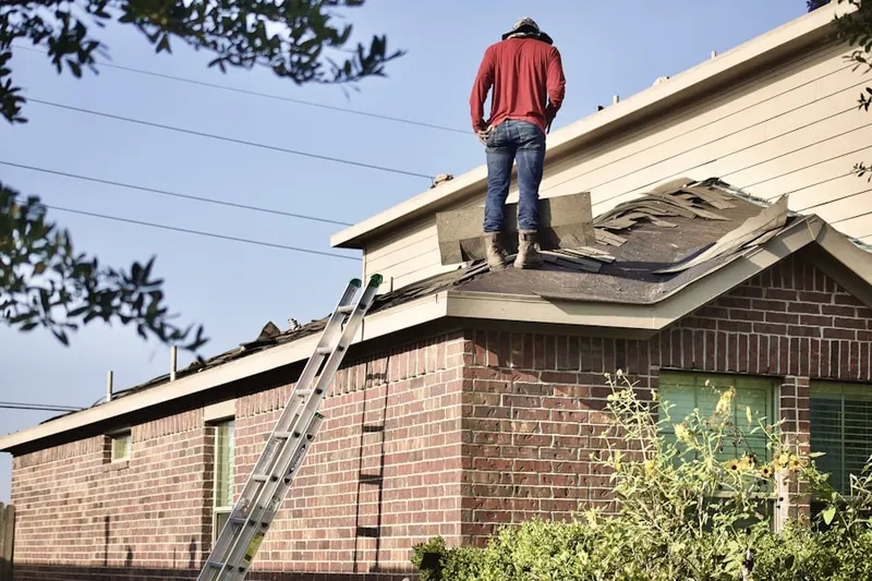 Professional roofer working on a residential roof in Maywood